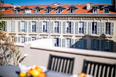 a large white building with a red roof at Palais l'Escurial AP4069 by Riviera Holiday Homes in Nice