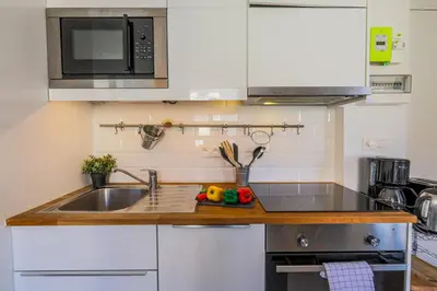 a kitchen with a sink and a microwave at Palais l'Escurial AP4069 by Riviera Holiday Homes in Nice