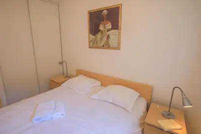 a white bed with a pair of towels on it at PALAIS LIBERTE in Nice