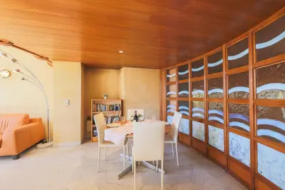 a dining room with a table and chairs at Quai des Marinières AP2015 by Riviera Holiday Homes in Villefranche-sur-Mer