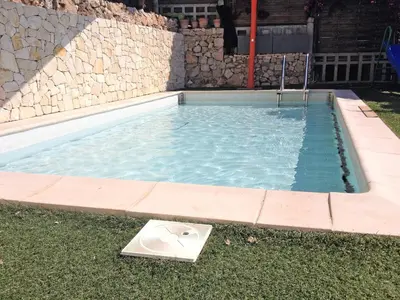 a swimming pool with a fan in the grass at Elegant Seaside Villa in Èze in Èze
