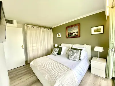 a bedroom with a bed with white sheets and pillows at Eden Barmassa in Villefranche-sur-Mer