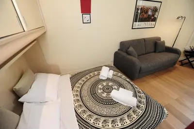 a living room with a couch and a table at Mini Suite Miro Five Stars Holiday House in Nice