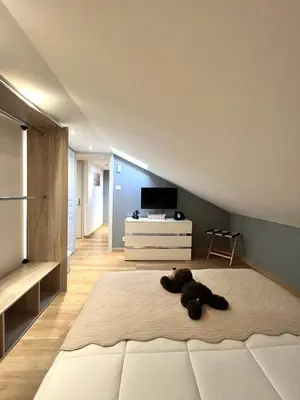 a teddy bear laying on a bed in a bedroom at DIEGO 4 pièces duplex in Nice