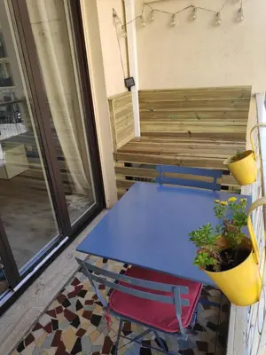 a blue table and a chair on a balcony at Best Apart - Nice Port - Balcony in Nice