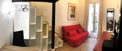 a living room with a red couch and a red chair at STUDIO DECO DESIGN, HYPER CALME in Nice