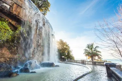 a waterfall in the middle of a pool of water at COCOON BEACH Central Proche Mer in Nice