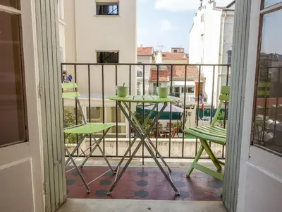 a balcony with a table and chairs on a balcony at Apartment France by Interhome in Nice