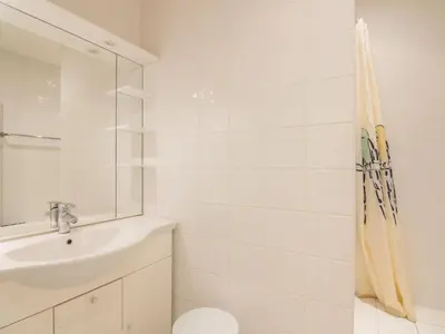 a white bathroom with a sink and a shower at Apartment Vieux Nice by Interhome in Nice