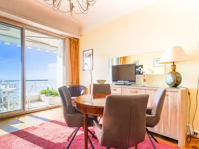 a dining room with a table and chairs and a television at Apartment La Floride Promenade des Anglais by Interhome in Nice