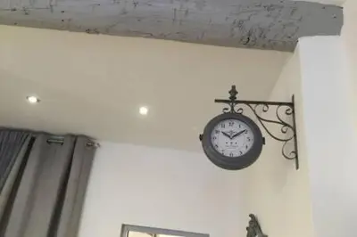 a clock hanging on a wall in a room at Beautiful apartment Rue De La Croix Vieux Nice in Nice
