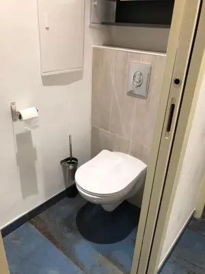a small bathroom with a toilet in a stall at California in Nice
