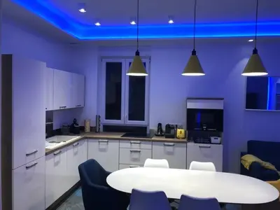 a large kitchen with a white table and chairs at California in Nice