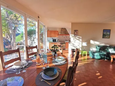 a dining room with a table and chairs and a kitchen at Holiday Home Agora by Interhome in Nice
