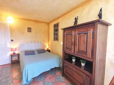 a bedroom with a bed and a wooden cabinet at Holiday Home Agora by Interhome in Nice