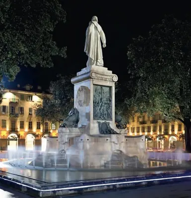 a statue of a man in a fountain at night at Appartement Les Plages in Nice