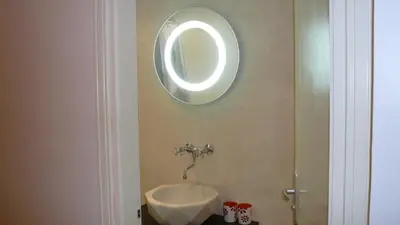 a bathroom with a sink and a mirror on the wall at Appartements Vieux Nice / Marché aux fleurs in Nice