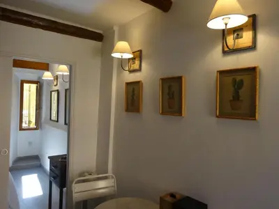 a bathroom with a toilet and pictures on the wall at Appartements Vieux Nice / Marché aux fleurs in Nice