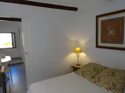 a bedroom with a bed and a picture on the wall at Appartements Vieux Nice / Marché aux fleurs in Nice