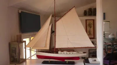 a wooden sail boat on a table in a room at Appartements Vieux Nice / Marché aux fleurs in Nice