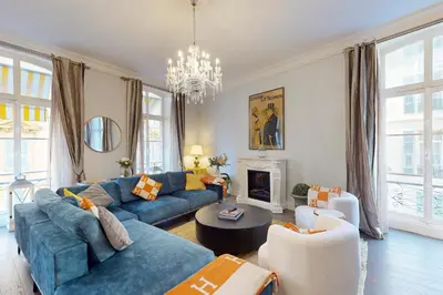 a living room with blue couches and a chandelier at Silver Suite Five Stars Holiday House in Nice