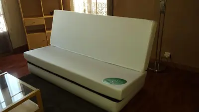 a white couch sitting on the floor in a room at Appartement Buenos Aires in Nice