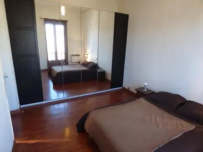 a bedroom with two beds and a mirror at Appartement Buenos Aires in Nice