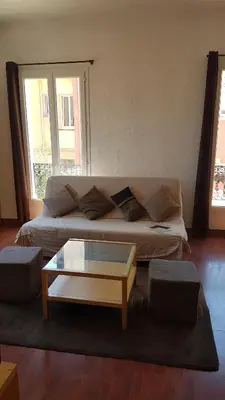 a living room with a couch and a coffee table at Appartement Buenos Aires in Nice