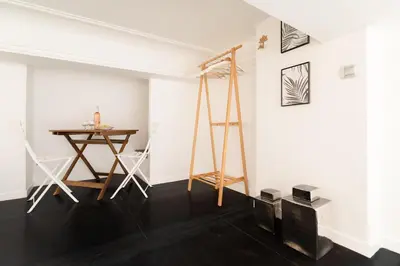 a room with a table and chairs and a ladder at Maison Bianchi - Duplex old town in Nice