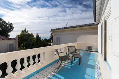 a balcony with chairs and a swimming pool at Stylish Art Deco villa near the sea 4 Bdrs Pool and garage in Nice