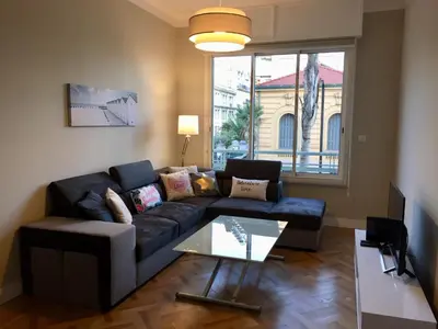 a living room with a couch and a table at NICE 115 BY THE SEA in Nice