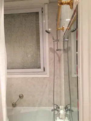 a bathroom with a shower and a sink and a tub at NICE 115 BY THE SEA in Nice