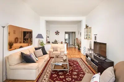 a living room with a couch and a tv at Sunlight Properties - 