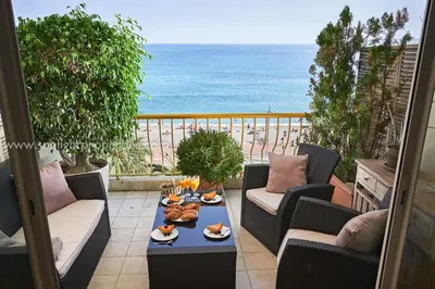 a balcony with a table with food and the ocean at Sunlight Properties - 
