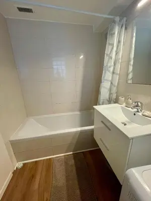 a white bathroom with a tub and a sink at Super studio in the heart of Nice! in Nice