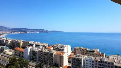 a kitchen with a black door and a counter at Sea View Apartment in Nice