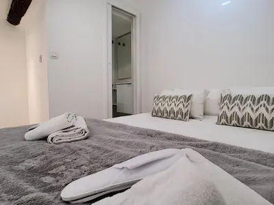 a bedroom with two beds with towels on them at Nestor&Jeeves - DUPLEX MIROIR - Hyper center - Shopping area - Top floor in Nice