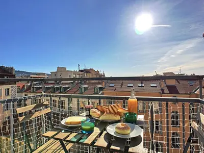 a table with two plates of food on a balcony at Nestor&Jeeves - DUPLEX MIROIR - Hyper center - Shopping area - Top floor in Nice