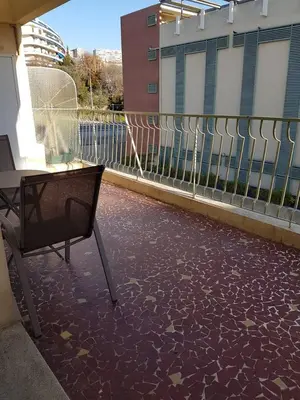 a balcony with a table and a chair on a patio at Sci MDM in Nice