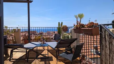 a patio with a table and chairs on a balcony at Le Château - THE MOST BEAUTIFUL SIGHT IN OLD TOWN, private terrace in Nice