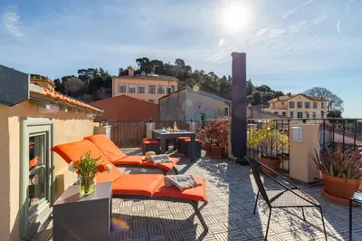 a balcony with orange cushioned chairs on a roof at Le Château - THE MOST BEAUTIFUL SIGHT IN OLD TOWN, private terrace in Nice