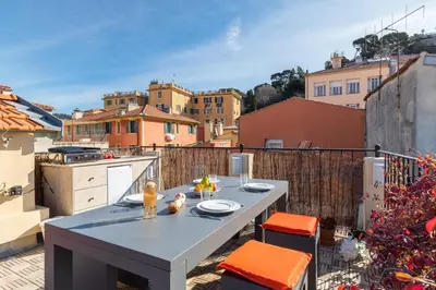 a patio with a table and chairs on a balcony at Le Château - THE MOST BEAUTIFUL SIGHT IN OLD TOWN, private terrace in Nice