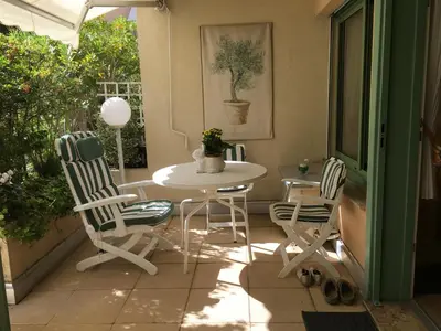 a patio with a table and chairs on a porch at Studio cosy à Villefranche sur mer in Villefranche-sur-Mer