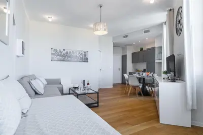 a white apartment with a living room and a kitchen at Gorgeous 1 Bdr with gardens view in the Old Town in Nice