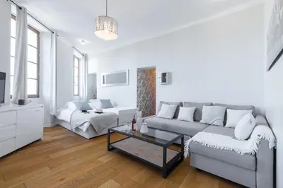 a white living room with a couch and a table at Gorgeous 1 Bdr with gardens view in the Old Town in Nice