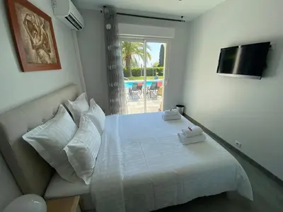 a bedroom with a white bed and a window at Diamond Villa 5 Star - NICE in Nice