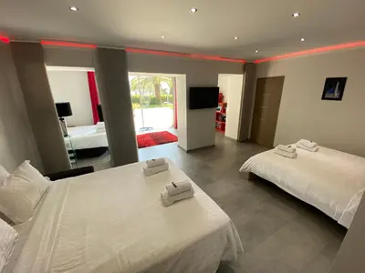 a hotel room with two beds and a television at Diamond Villa 5 Star - NICE in Nice