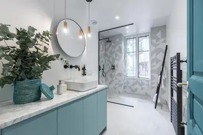 a bathroom with a sink and a mirror at L'Abeille - Boutique Apartments in Nice