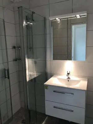 a bathroom with a sink and a shower with a mirror at Nice/Villefranche in Villefranche-sur-Mer