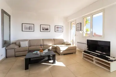 a living room with a couch and a tv at HENRIETTA AP4070 - avenue Soleil d'Or - Villefranche-sur-Mer in Villefranche-sur-Mer